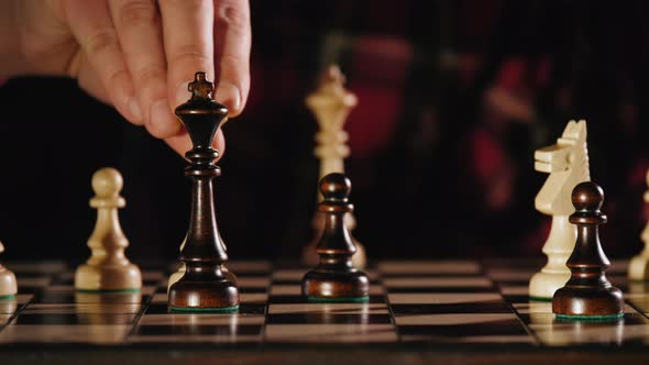 Front View of White Queen Defeating Black King During Chess Game alt