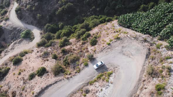 4K .Aerial landscape. Fly over mountain road with car top view alt