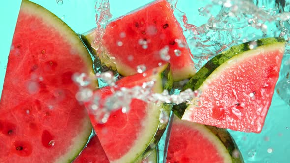 Super Slow Motion Shot of Falling Fresh Watermelon Slices Into Water at 1000Fps. alt