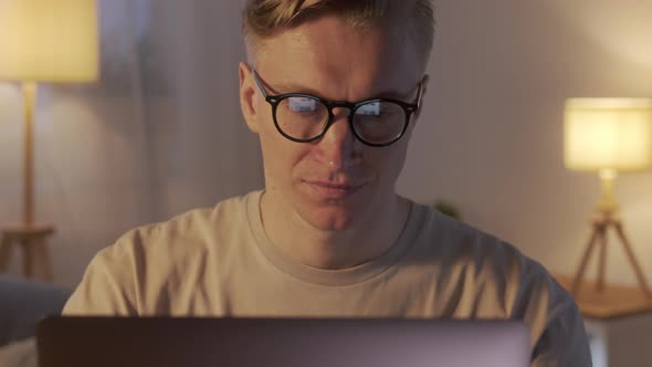 Close Up Young Man Freelancer Using Laptop Typing Scrolling Surfing Web Looking at the Screen
