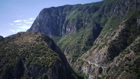 Aerial View Around a Bare Valley Amidst Mountains and Foliage in Sunny Abruzzo alt