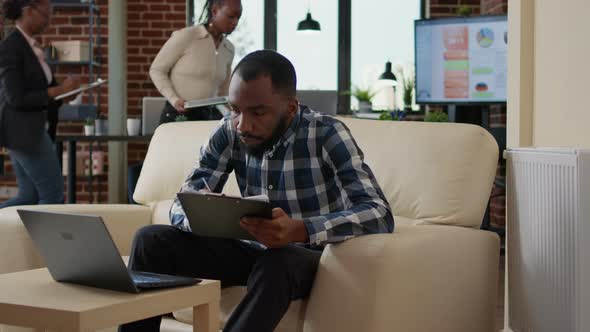 Portrait of Young Man Working with Information on Laptop alt