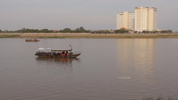 Boats going across the Mekong River in Phnom Penh, Cambodia alt