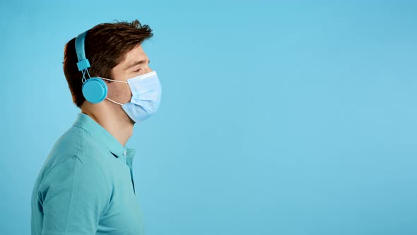 Copy Space. Handsome Young Man with Protective Mask Having Fun, Smiling, Dancing Head with Blue alt