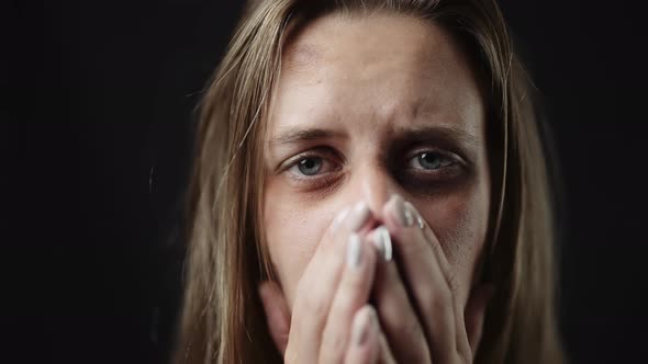 A Sad Beaten Up Woman with Tear in Eye and Bruises is Crying alt