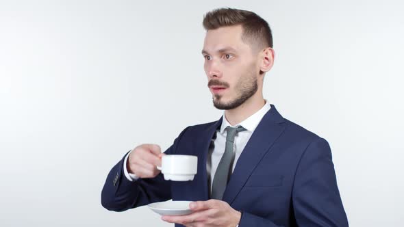 Businessman Staring into Space and Drinking Coffee alt