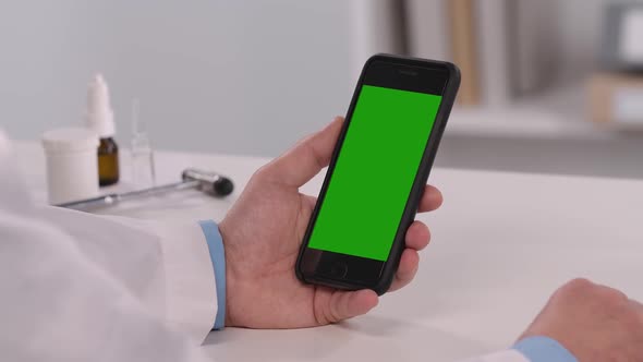 Male Doctor Consults Patient Using Mobile Phone with Green Screen Chroma Key alt