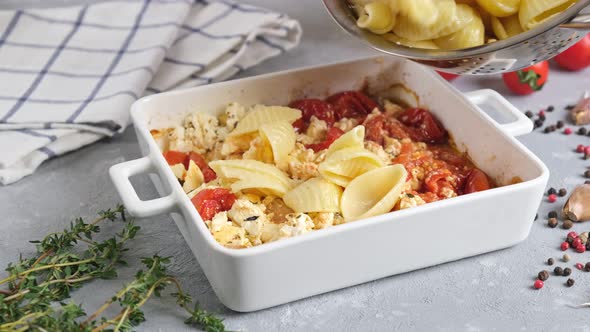 Trending viral recipe of baked tomatoes and feta with pasta, Fetapasta on a light background.