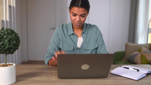 Satisfied Ethnic Female Using Laptop for Remote Work or Studying