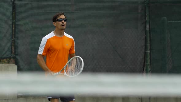 Tennis player practicing his return stance. alt