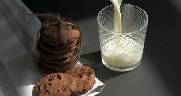 Glass is Filled with Milk and Homemade Cookies on the Table