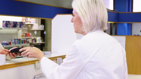 Customer entering pin code on payment terminal alt