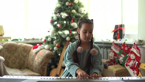 Christmas Child Little Girl Playing on Piano at Home