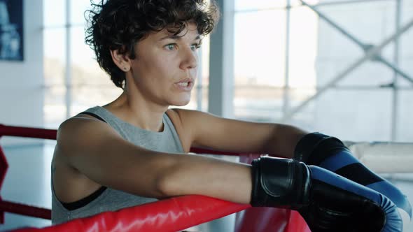 MMA Fighter Pretty Girl Breathing Hard Resting in Ring Corner in Gym alt