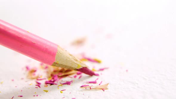 Pink broken colored pencil on white background alt