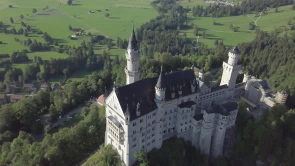 Aerial view of Neuschwanstein Castle in Bavaria Germany. Palace on green forest hills european Alps 