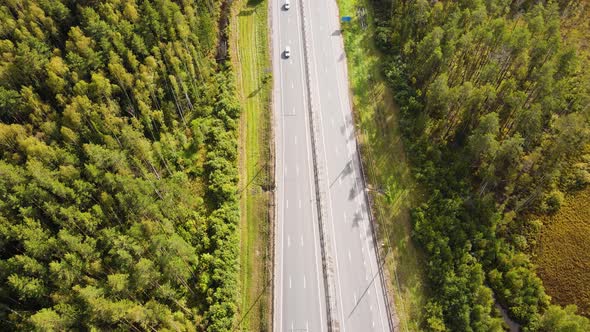 Aerial View of a Country Road and a Small Number of Moving Cars alt