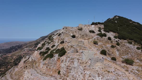 Mills in Motion on Mountain Peak By Mediterranean Sea Crete Greece