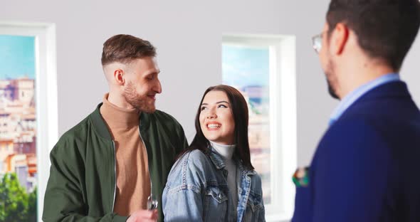 Close Up of Handsome Happy Caucasian Man Real Estate Realtor Giving Keys for New Apartment alt