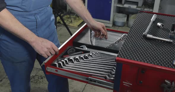 Auto Mechanic Opens A Box With Working Tools For Repair And Diagnostics Of Cars alt