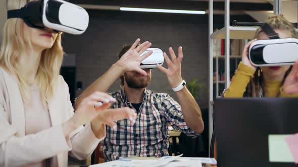 Young Modern Corporate Coworkers Working Together in Virtual Reality Headset alt