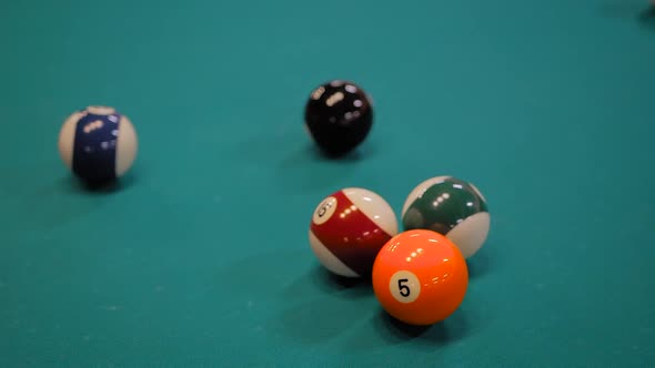 Slow Motion Hitting Colorful Pool Balls on Teal Billiard Table  Close Up