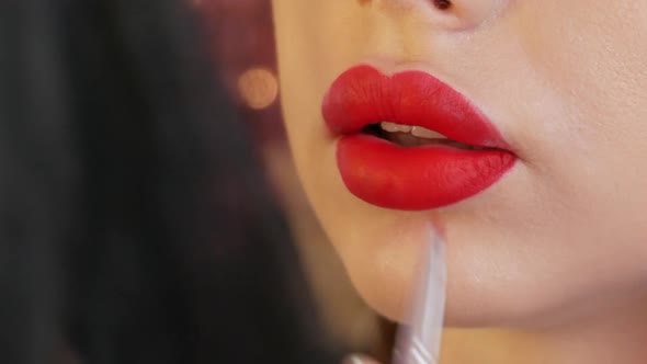 Bright Lip Makeup Big Beautiful Lips are Painted with Red Lipstick with a Special Brush in a Beauty alt