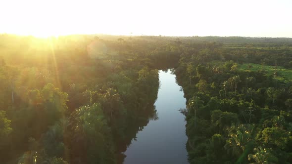 Sun Setting, Over A River In The Amazon Rainforest