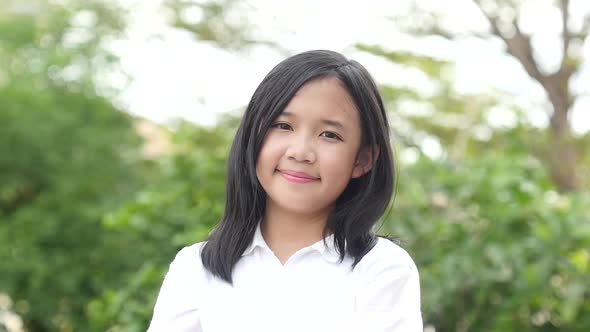 Beautiful Asian Girl Looking At Camera On Nature Background alt