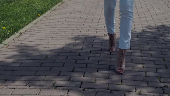 Stylish Woman Walking on Path in Park alt