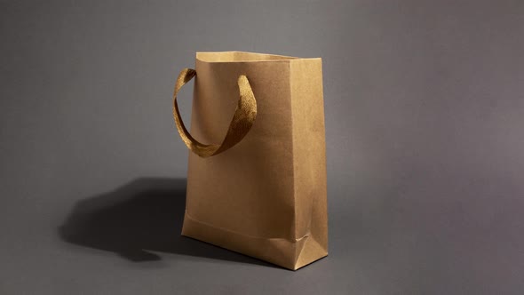 Stop Motion Animation with Craft Paper Shopping Bag on Dark Background