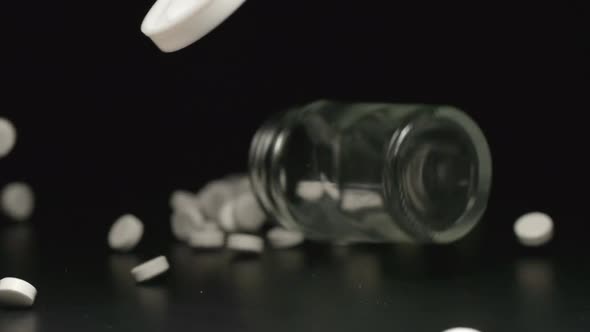 Glass jar falls and pills with cover fall out of him
