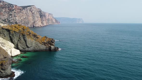 Aerial View From Above on Azure Sea and Volcanic Rocky Shores alt