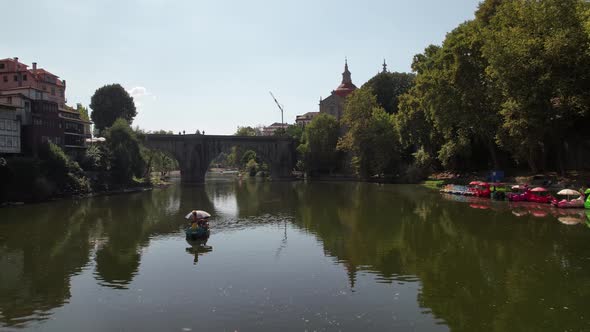 Medieval Stone Bridge Over River Tâmega and Castle in Amarante Town of Portugal, aerial view alt