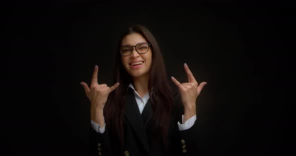 Young Beautiful Businesswoman Shows a Rock Symbol with Her Hands