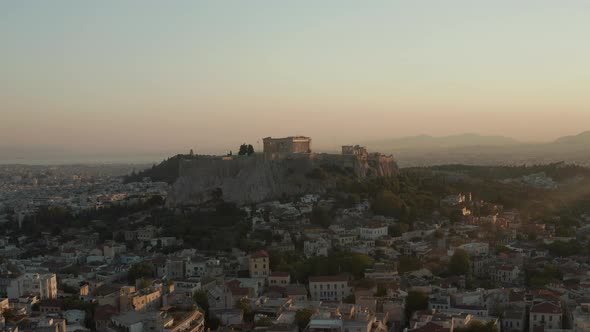 Slow Aerial Dolly Towards Mountain with Acropolis of Athens in Greece in Beautiful Golden Hour alt