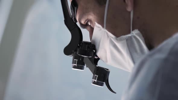 Surgeon head with professional glasses at work alt