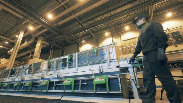 Person Works with Machine at Recycling Center alt