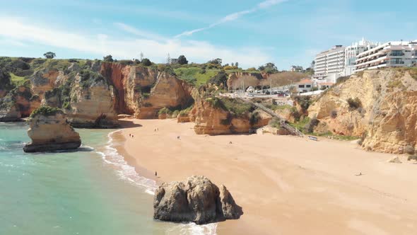 People enjoying majestic shoreline of heavenly Dona Ana beach, Lagos, Algarve, Portugal alt