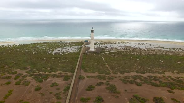 Aerial view of Morro Jable Lighthouse with cloudy weather. alt