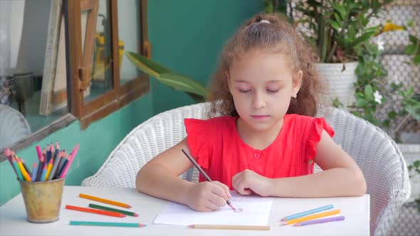 Cute Small Little Girl Artist Playing Alone Drawing Coloring Picture with at Home Relaxing Sits in alt