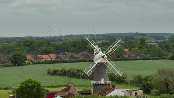 Old Windmill And New Wind Turbines Bircham, Norfolk, UK Aerial View