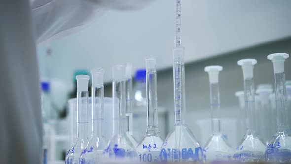 Worker Chemist Dripping Liquid Into Test Tube Flask Spbd alt