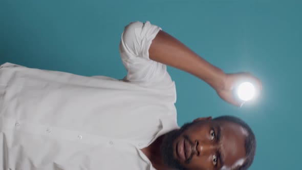 Vertical Video Confused Adult Using Lanternt to Look Around and Search alt