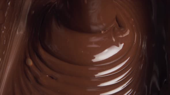 Melted chocolate pouring in a candy factory