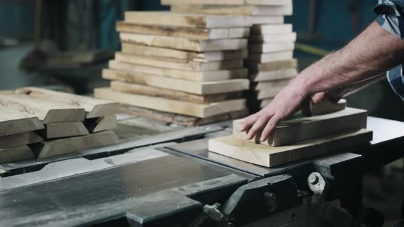 Closeup of Hands and Wood Workpiece on Planer alt