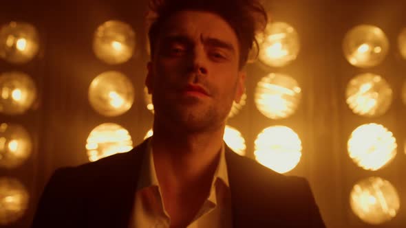 Sexy Man Model Walking Confidently in Spotlights Wearing Elegant Suit Close Up alt
