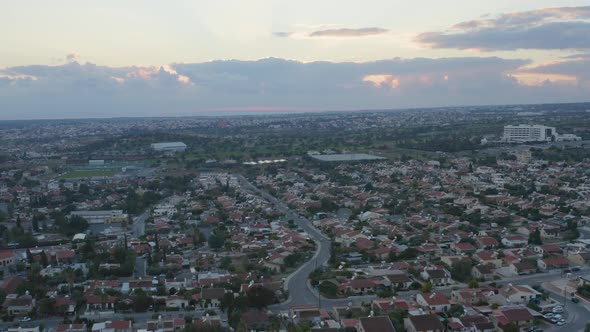 Aerial Shot of Cityscape with Cloudy Sky at Sunset