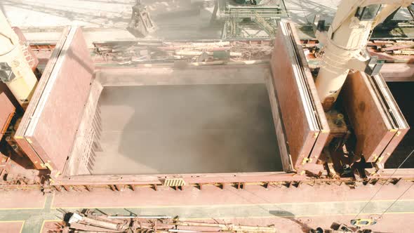 Loading dry cargo ship of wheat by cranes in port. alt