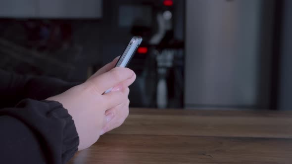 Woman Using the Phone at Home Closeup Writes SMS Surfs the Internet Cinematic Shot alt
